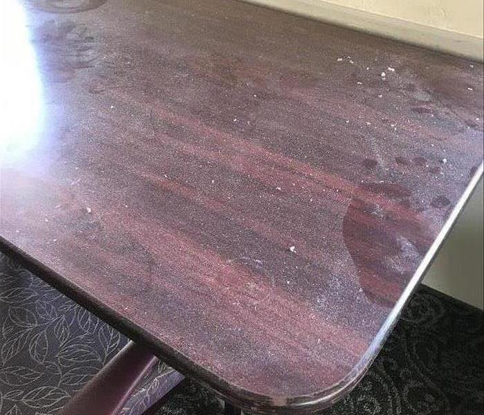 Soot and insulation on table before cleaning